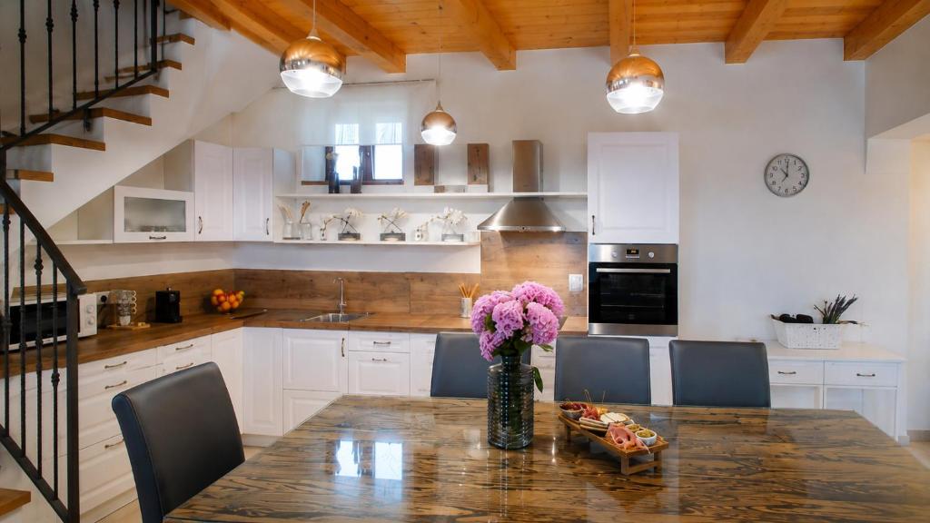 a kitchen with a table with a vase of flowers on it at Residence Panorama in Buzet