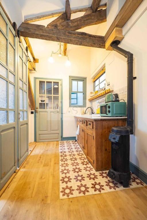 a kitchen with wooden floors and a kitchen with a counter at Sol By Silastur in Villaviciosa