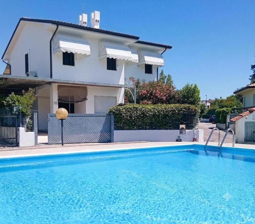 a villa with a swimming pool in front of a house at Luxury Villa Duna Verde in Duna Verde