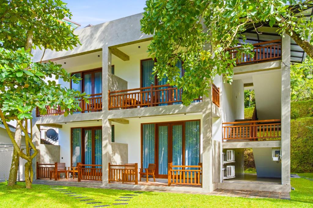 an exterior view of a house with balconies at Darlina Hiriketiya in Hiriketiya