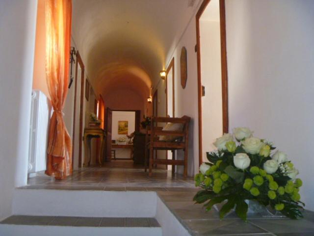 a hallway with a vase of flowers on the floor at Dimora San Pietro in Ferrandina