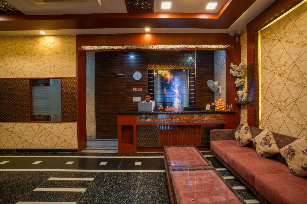 a lobby of a hotel with a couch and a bar at Hotel Kiaara in Varanasi