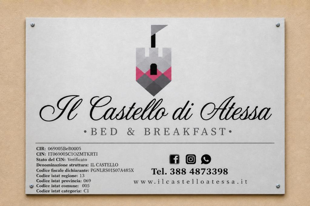 a black and white ticket for a party with a grey and pink tie at Il Castello di Atessa in Atessa