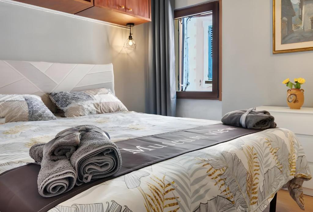 a bedroom with a bed with a blanket on it at Museum view, Vista sul museo B in Sassello