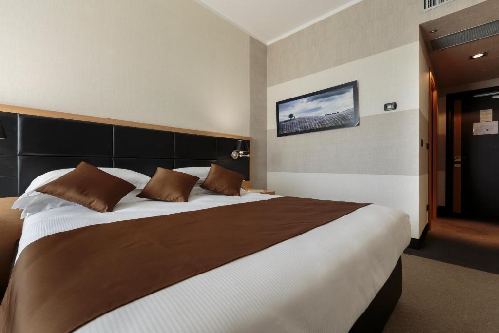 Łóżko lub łóżka w pokoju w obiekcie Hotel Pineta Wellness & Spa