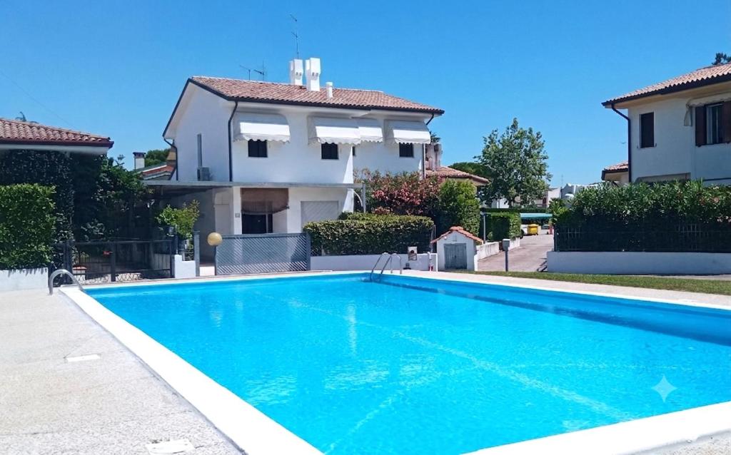 a swimming pool in front of a house at Villa Duna Verde in Duna Verde