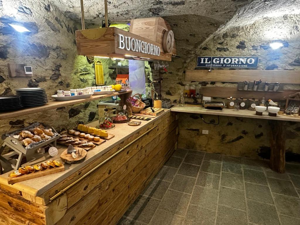 a kitchen with a buffet of food in a restaurant at B&B FANCHETTI 1938 in San Sebastiano