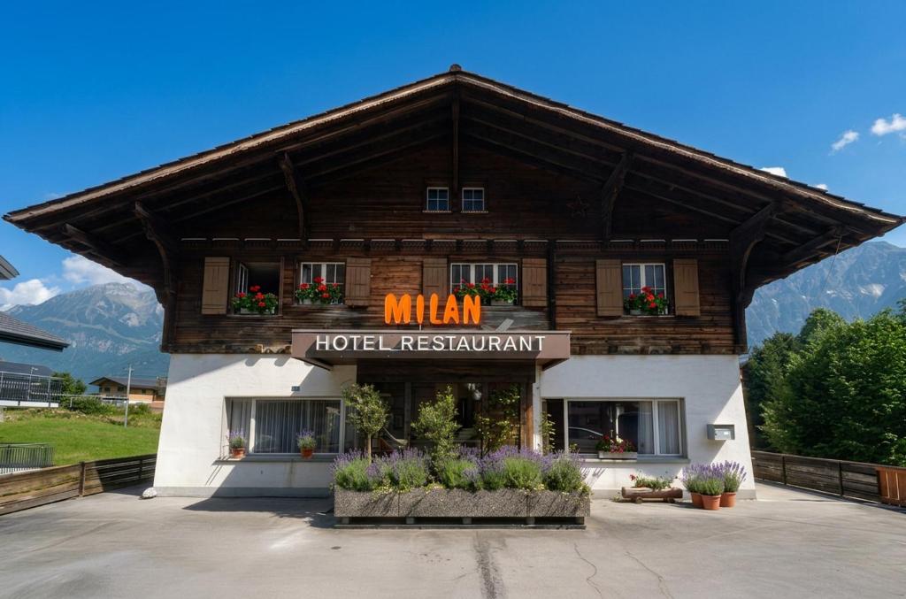 a building with a sign that reads mhm hotel restaurant at Hotel Milan - Self Check-In in Ringgenberg
