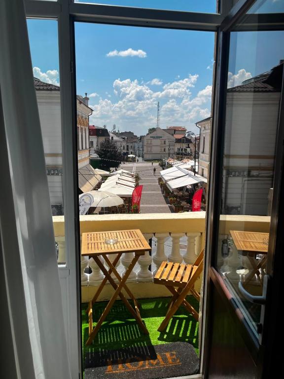 a view from a window of a balcony with a picnic table at Vibe 90 Old Town Apartment Craiova in Craiova