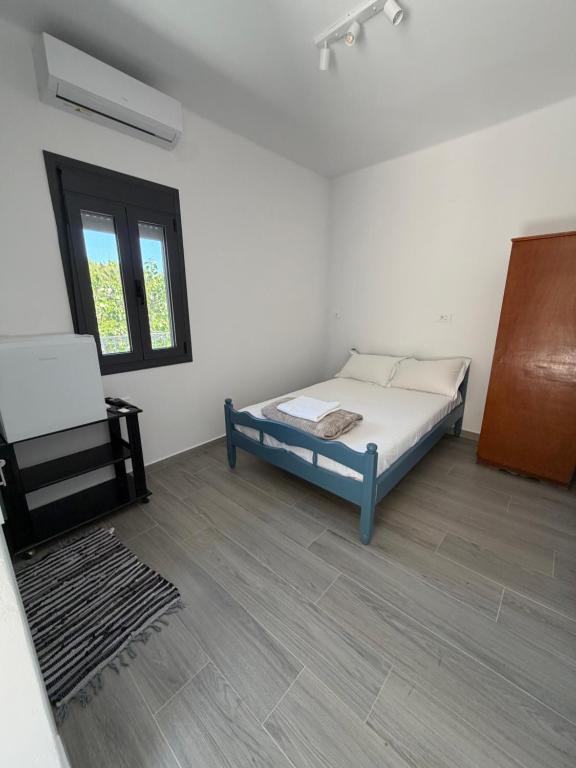 a bedroom with a bed and a chair in it at Kaloniki Rooms & Suites in Masouri