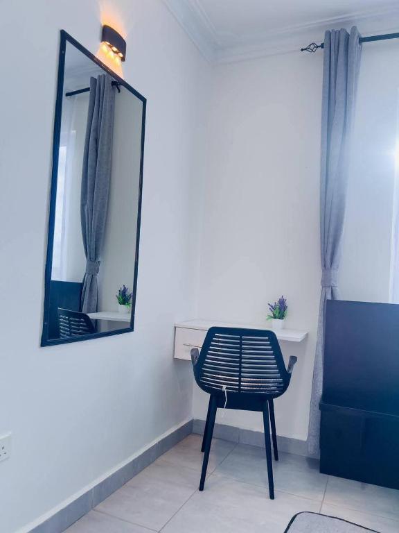 a mirror and a chair in a room at The palace001 in Mombasa