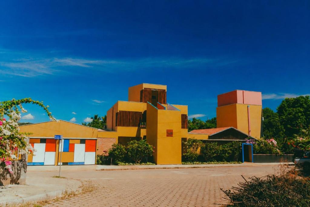 a building with colorful squares on it on a street at Pousada dos Bougainvilles in Manhã