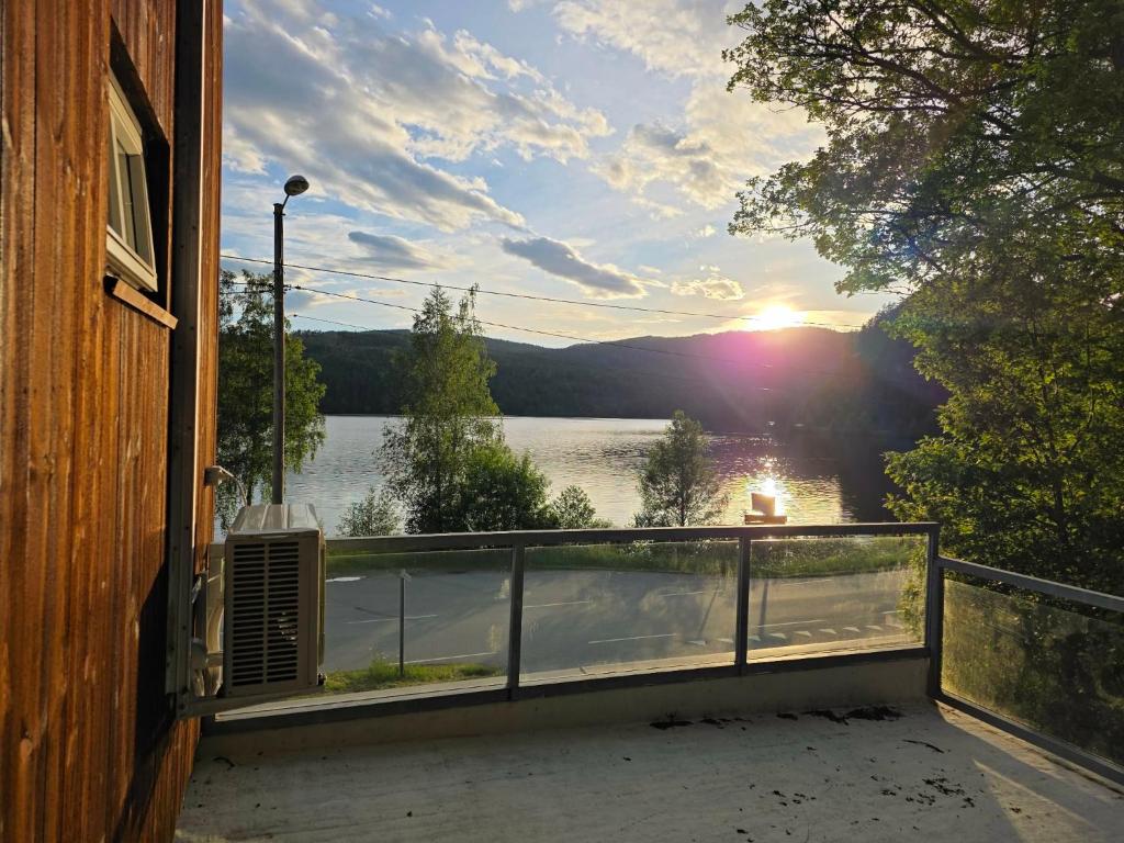 a balcony of a house with a view of a lake at Leilighet ved vannet in Konsmo