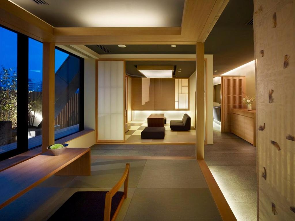 a living room with a couch and a large window at hotel kanra kyoto in Kyoto