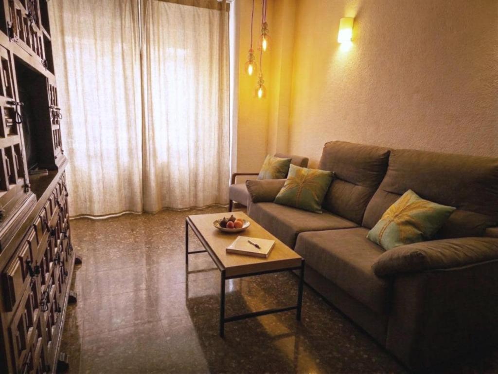 a living room with a couch and a coffee table at Casa Centro 48 by Eden Mar - Ideal para estancias temporales in Guardamar del Segura
