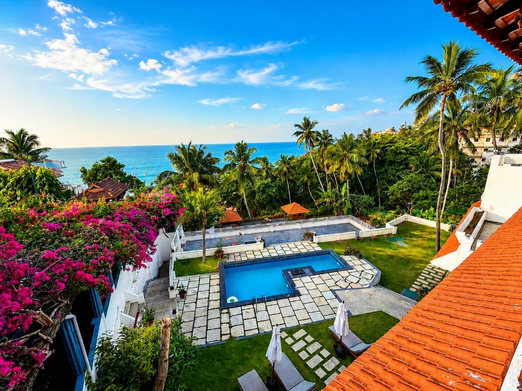 an aerial view of a villa with a swimming pool at Getaway Beach Resort Kovalam in Kovalam
