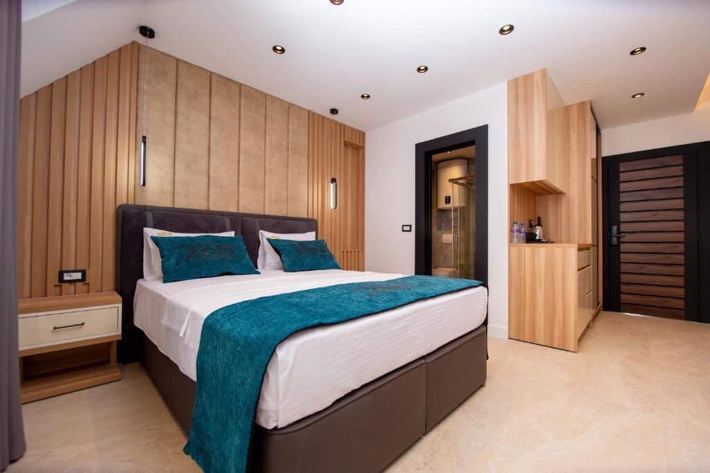 a bedroom with a large bed with blue pillows at Premium Apartments Zevs in Budva