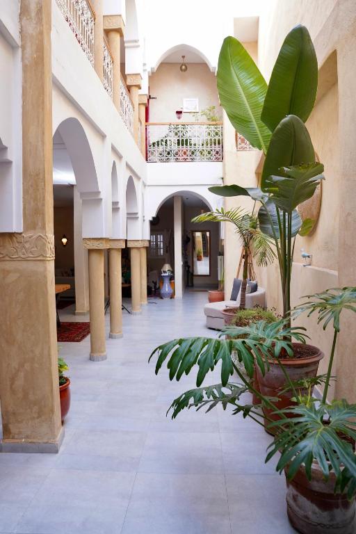 a hallway with potted plants in a building at Dar Halima in Rabat