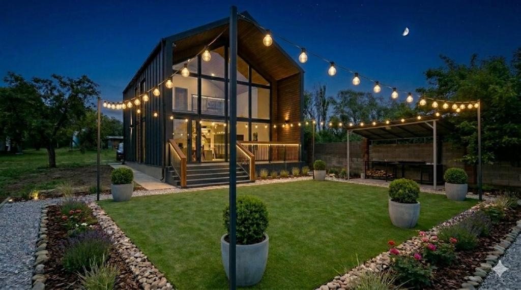 a house with lights in a yard at night at DreamHouse in Cholpon-Ata