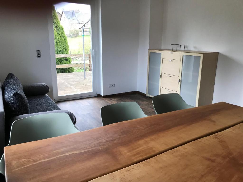 a conference room with a wooden table and chairs at Wohnung Regina in Wildenfels