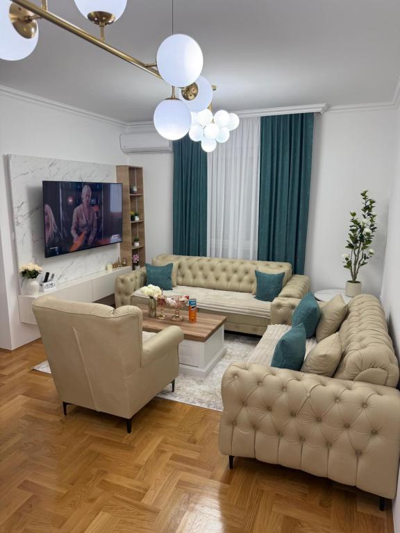 a living room with two couches and a tv at Stan na dan Alex in Bijeljina