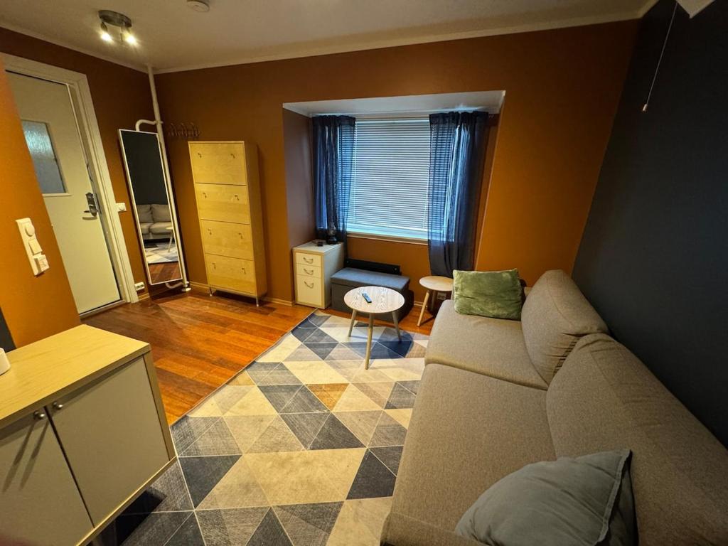 a living room with a couch and a table at Leilighet i Vadsoe sentrum in Vadsø