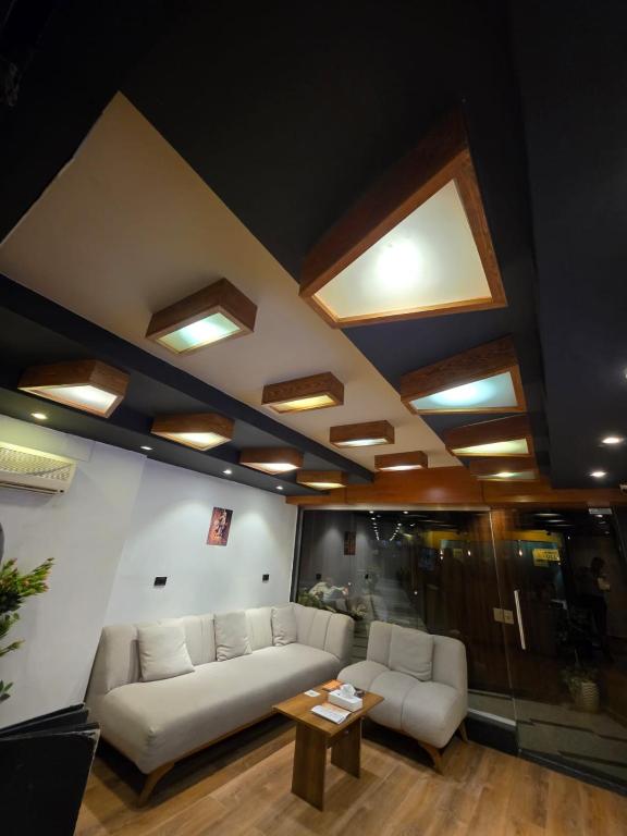 a living room with a couch and a table at Garden City Plaza Hotel in Cairo