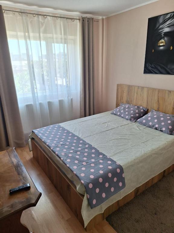 a bedroom with a bed with polka dot pillows at Vibe Apartament 17 in Galaţi