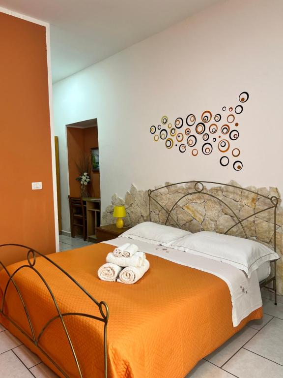 a bedroom with a bed with towels on it at Estía Holidays Apartments - Taormina in Taormina