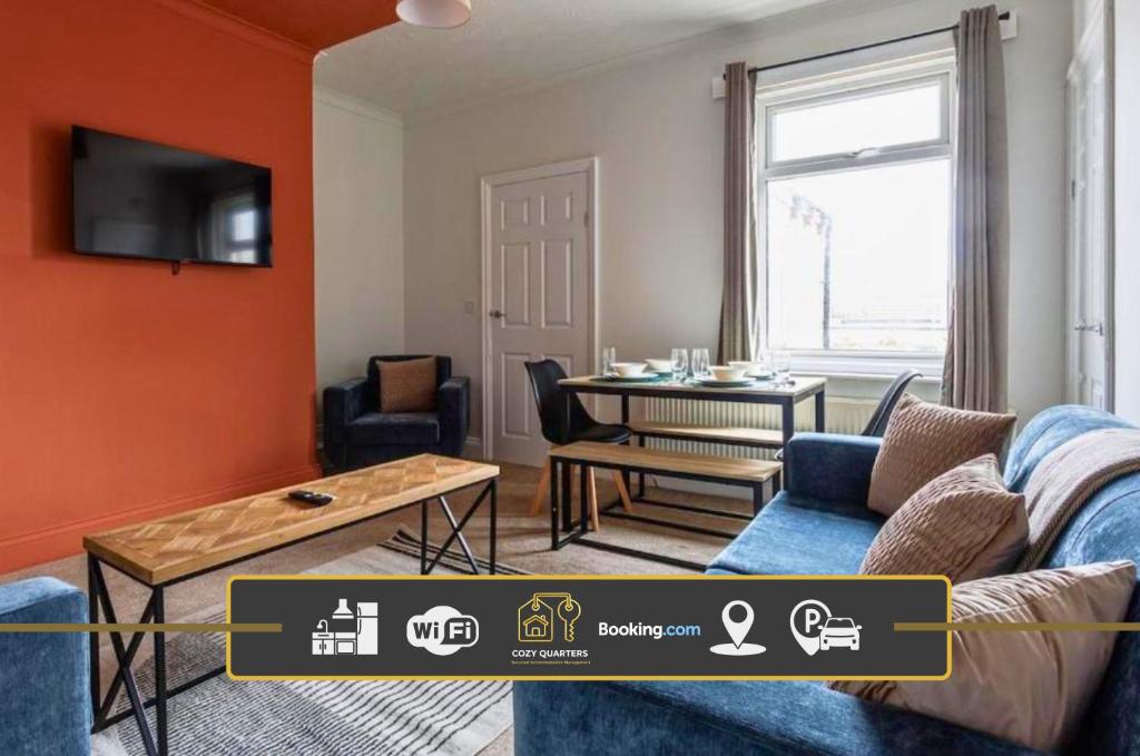 a living room with a blue couch and a table at 3 Bedroom House By Cozy Quarters Property Management Contractors Accommodation Seaham Near Sea in Seaham