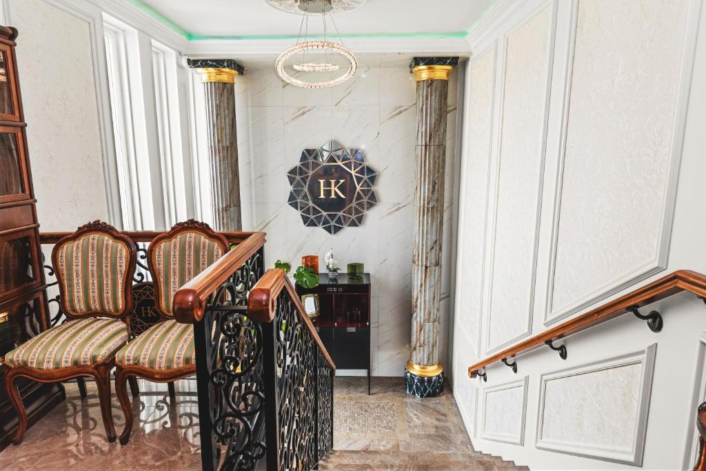 a staircase with chairs and a clock on the wall at Hotel Keflavik by Reykjavik Keflavik Airport in Keflavík