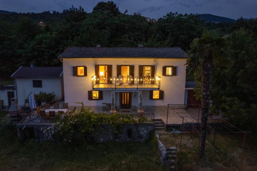 a house with a balcony with lights on it at More Garden in Opric