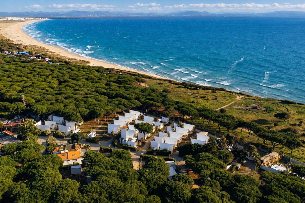 an aerial view of a beach with white buildings at Kampaoh Tarifa in Tarifa