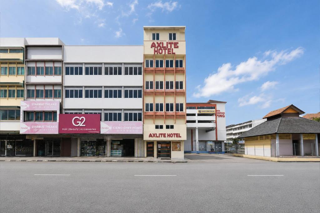 an empty parking lot in front of a building at Collection O Axlite Hotel in Taiping