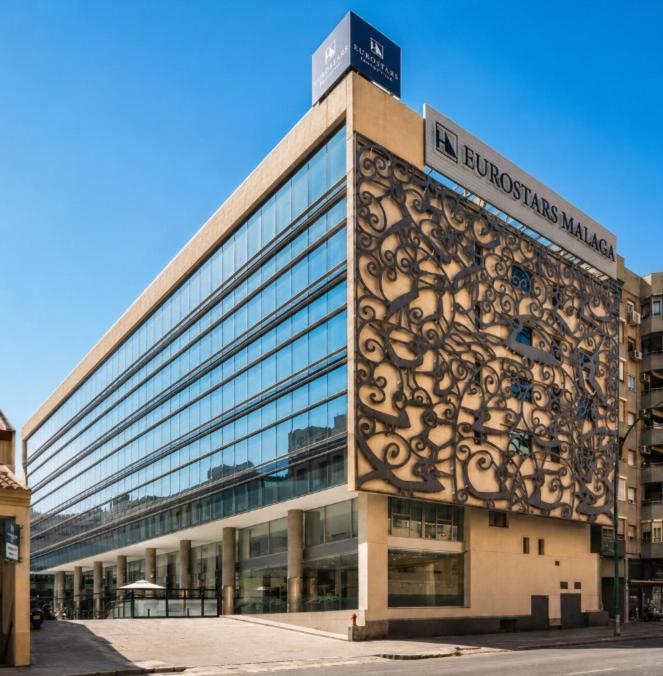 a large building with a sign on the side of it at Eurostars Málaga in Málaga