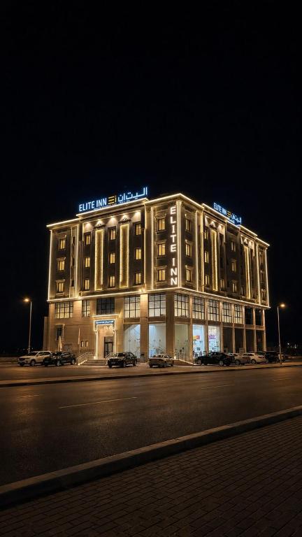 a lit up building on a street at night at إليت إن - ELITE INN Serviced Apartments in Qal'at Bishah