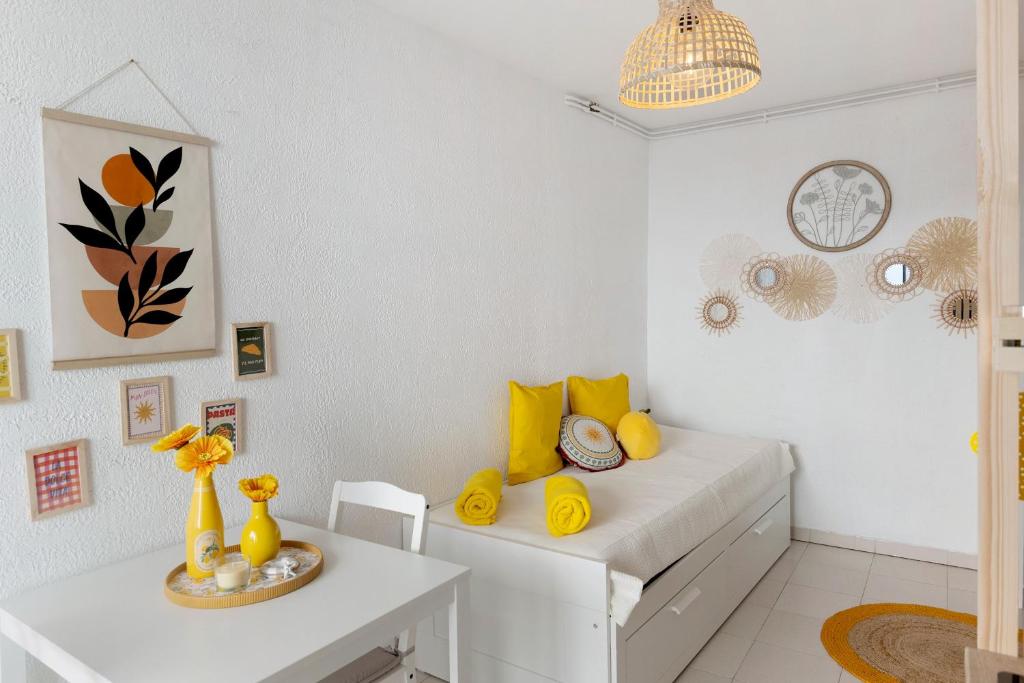 a white room with a bed and a table at O Sole Mio Zen Haven in Valras-Plage