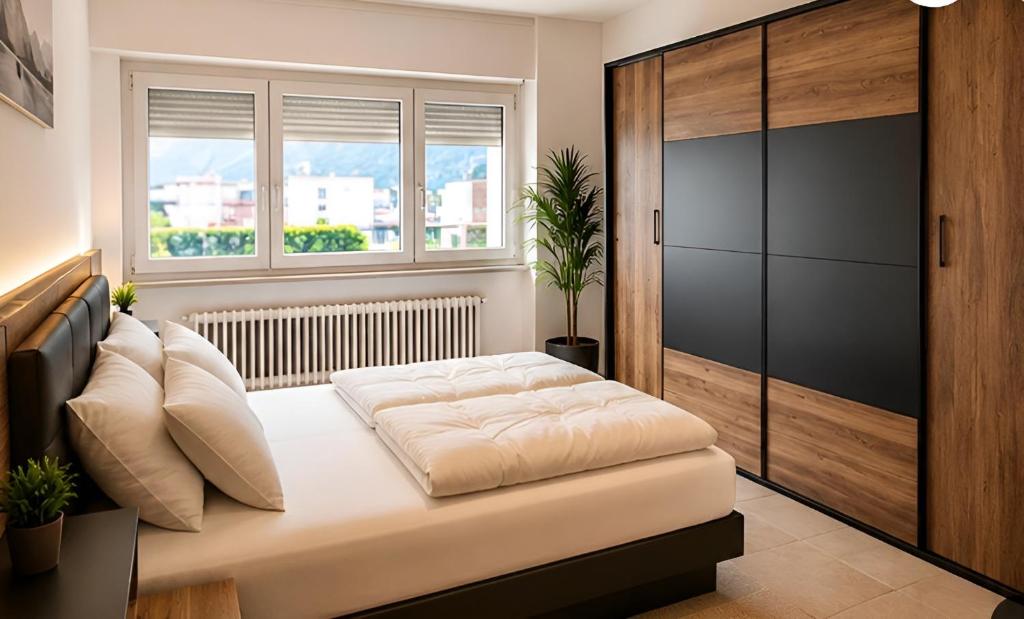 a bedroom with a bed and a window at B&B bellinzona gino in Bellinzona