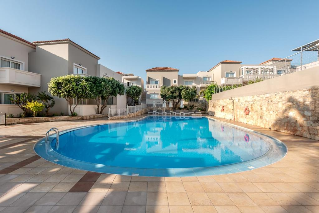 a swimming pool in a courtyard of a building at Solimar Topaz - Adults Only in Tavronitis