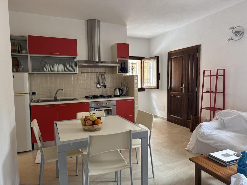 a kitchen with a table with a bowl of fruit on it at Casa Giulia in Palau