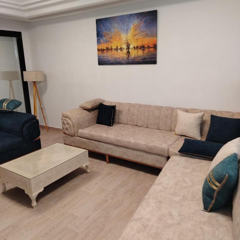 a living room with a couch and a coffee table at Kelibia Jinen EL mansoura in Kelibia