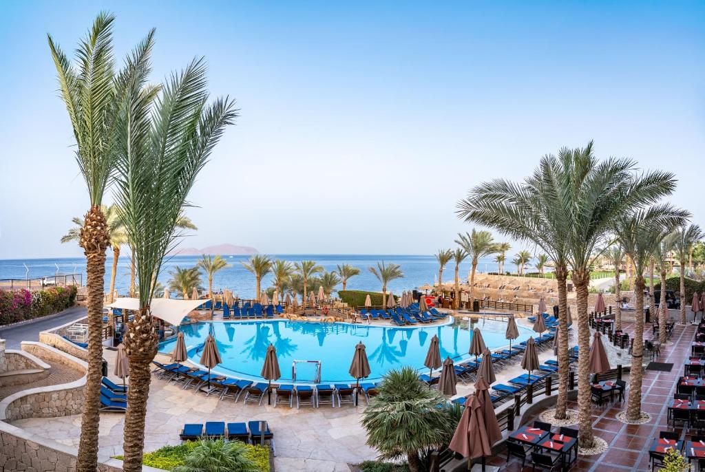 an overhead view of a resort with a pool and palm trees at Xperience Sea Breeze Resort in Sharm El Sheikh
