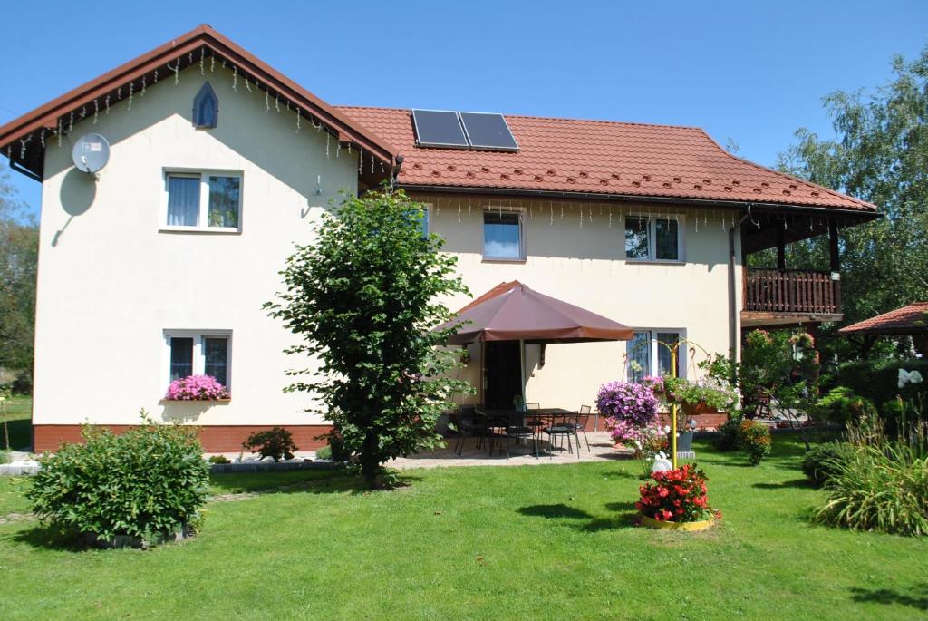a large white house with a red roof at Agroturystyka nad Sanem in Dydnia