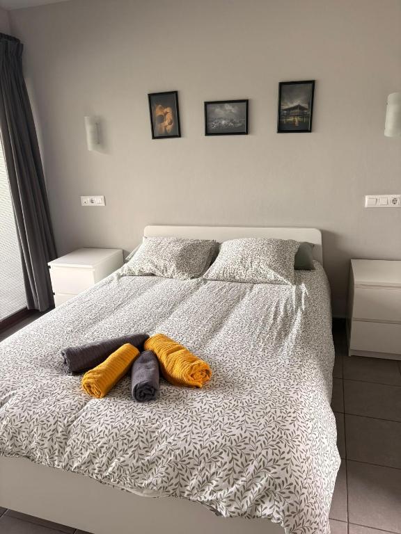 a bedroom with a bed with two towels on it at los jardines las rozas in Las Rozas