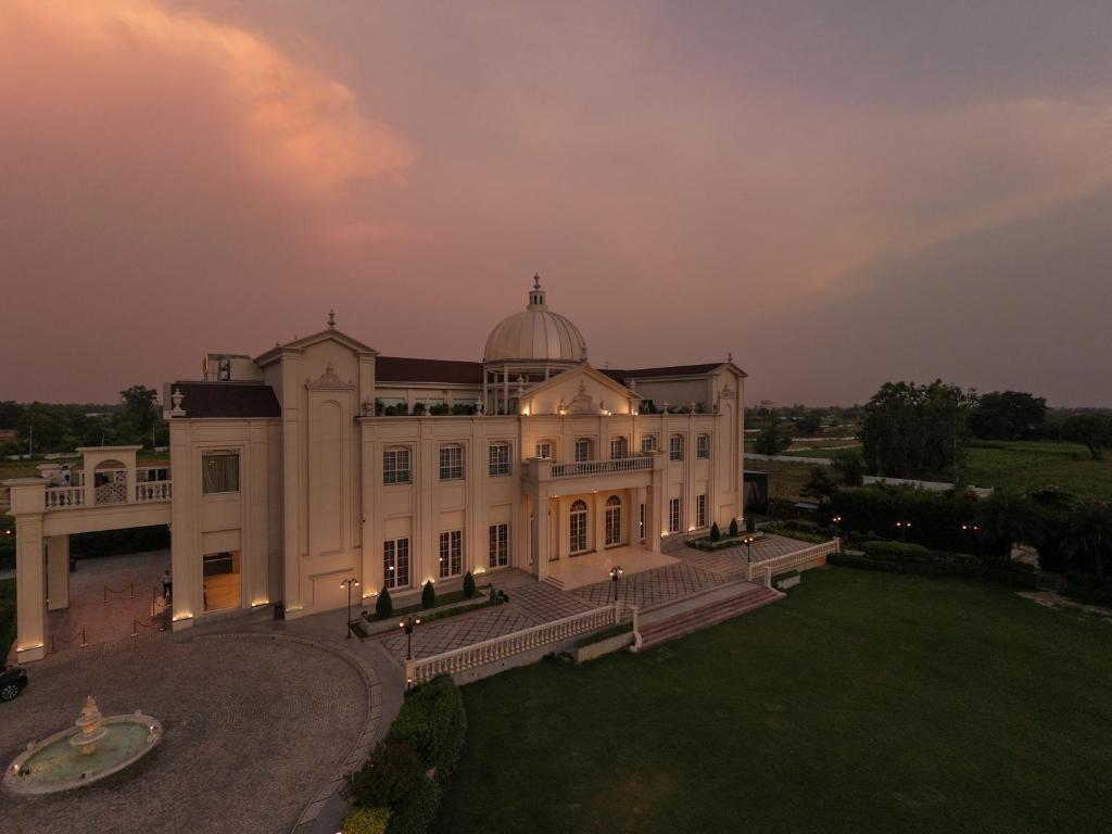 a large white building with a dome on top of it at Rajwada Hotel and Resort in Bareilly