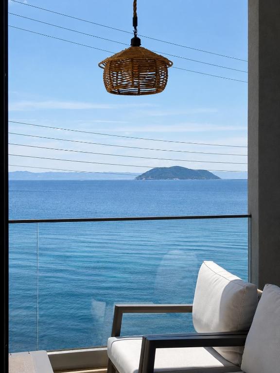 a living room with a view of the ocean at Candi Luxury Suites 2 in Neos Marmaras