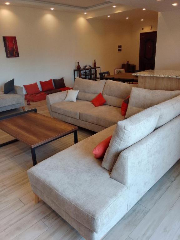 a living room with two couches and a table at sidi yahia,hydra in Hydra