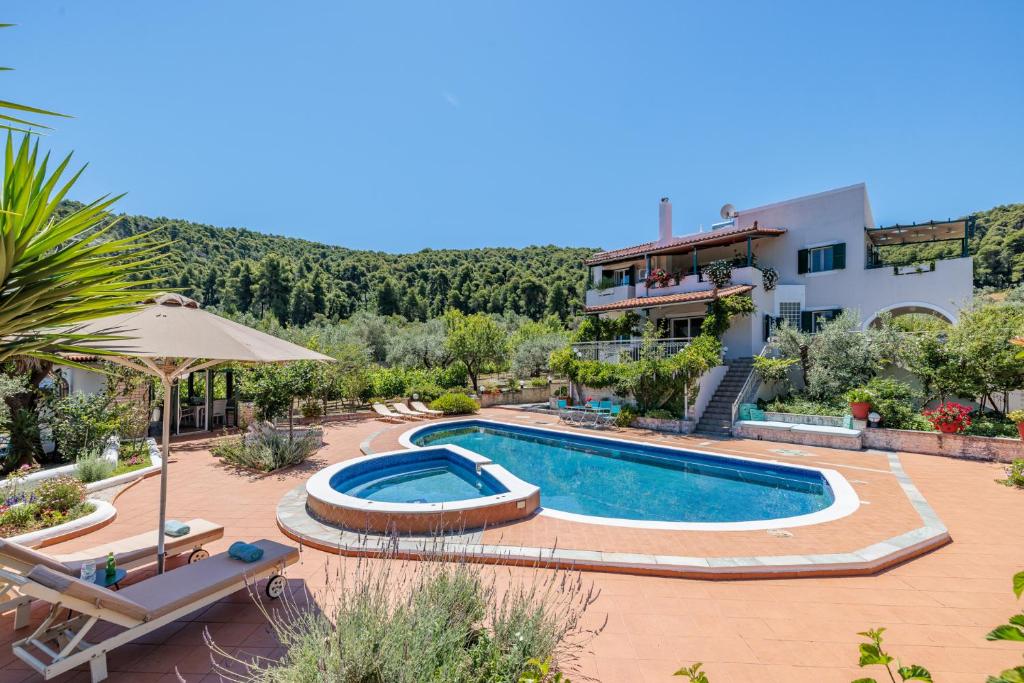 a villa with a swimming pool and a house at Nature Grand Estate - Spacious Villa with Pool in Skopelos Town