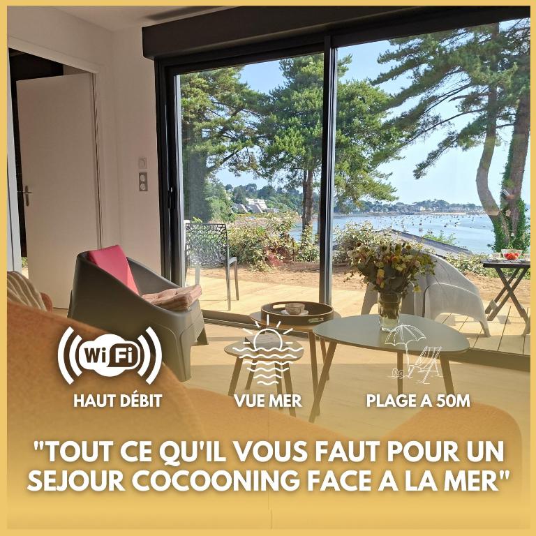 a room with a large window with a view of the ocean at Le chalet Ker Yann Vue mer Locquirec in Locquirec