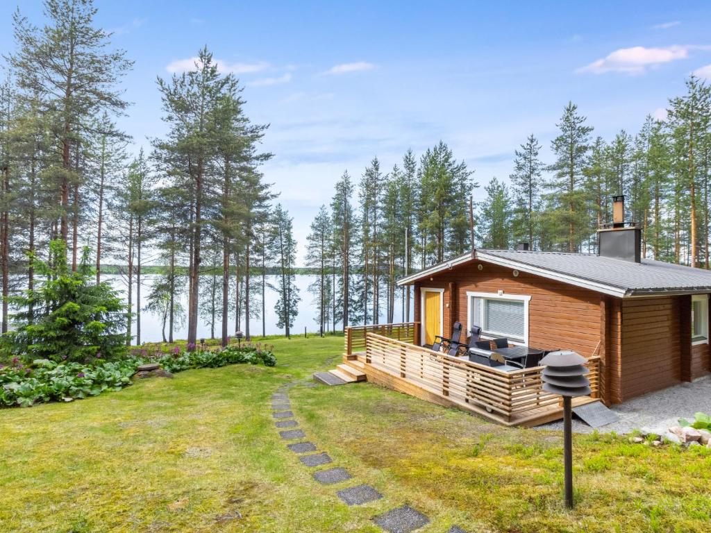 a cabin in the woods with a view of the water at Holiday Home Järvelä by Interhome in Kemijärvi